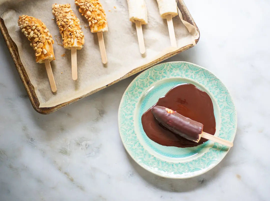 Frozen Dipped Banana Pops in melted chocolate