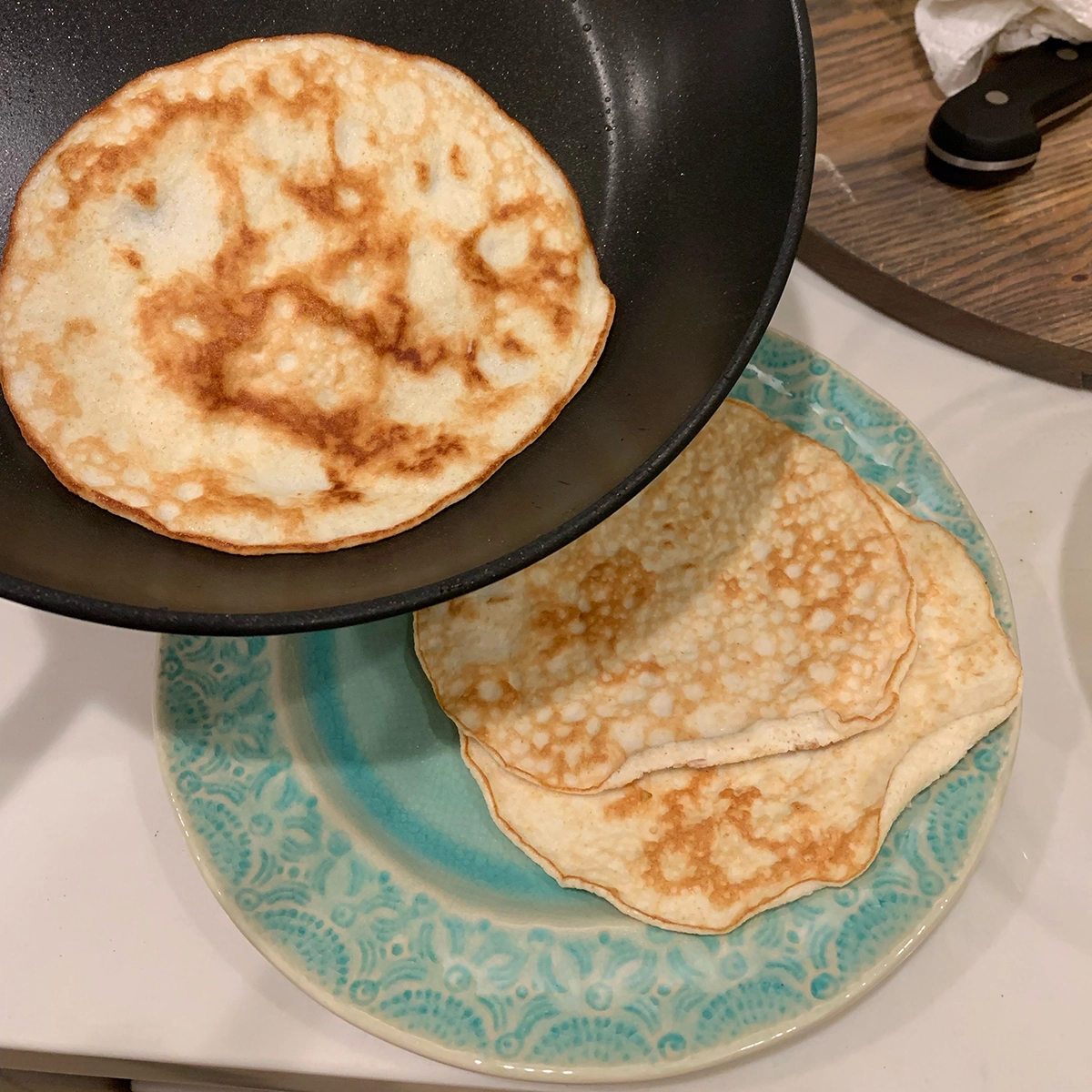 Tortillas in non-stick frying pan done and sliding out image