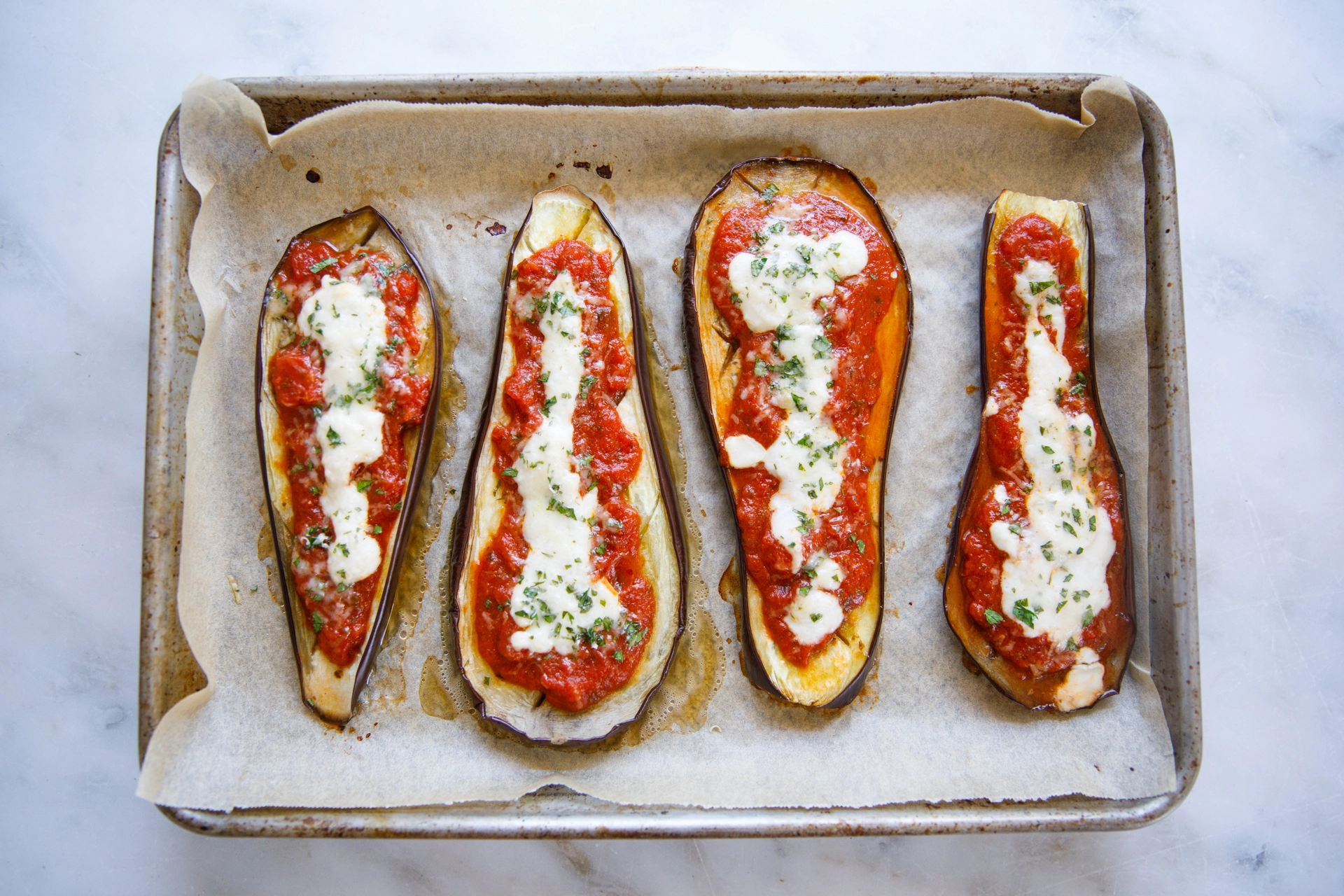 Eggplant Parmigiana quick and easy overhead on baking sheet