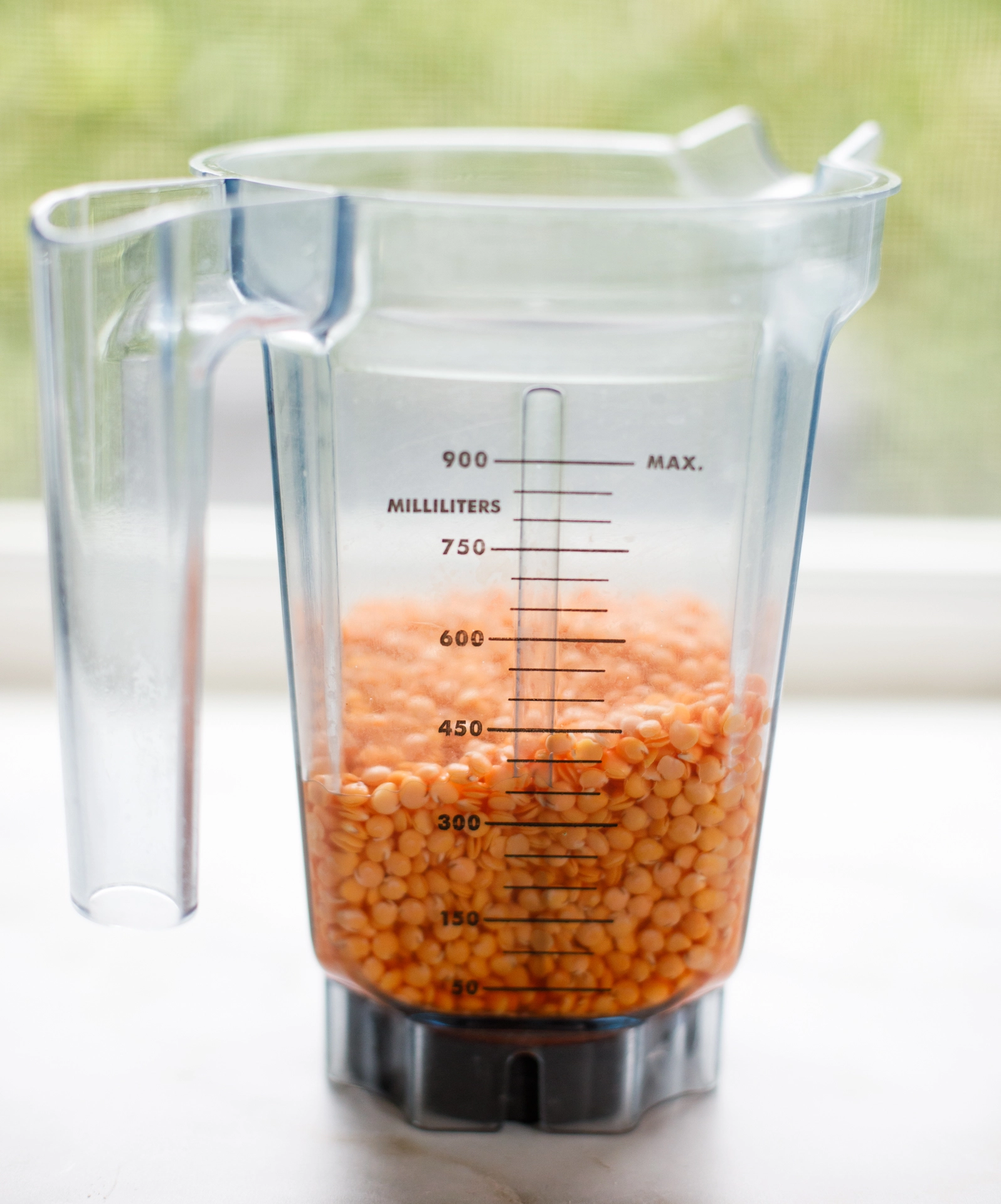 Red lentils soaking in water in blender container