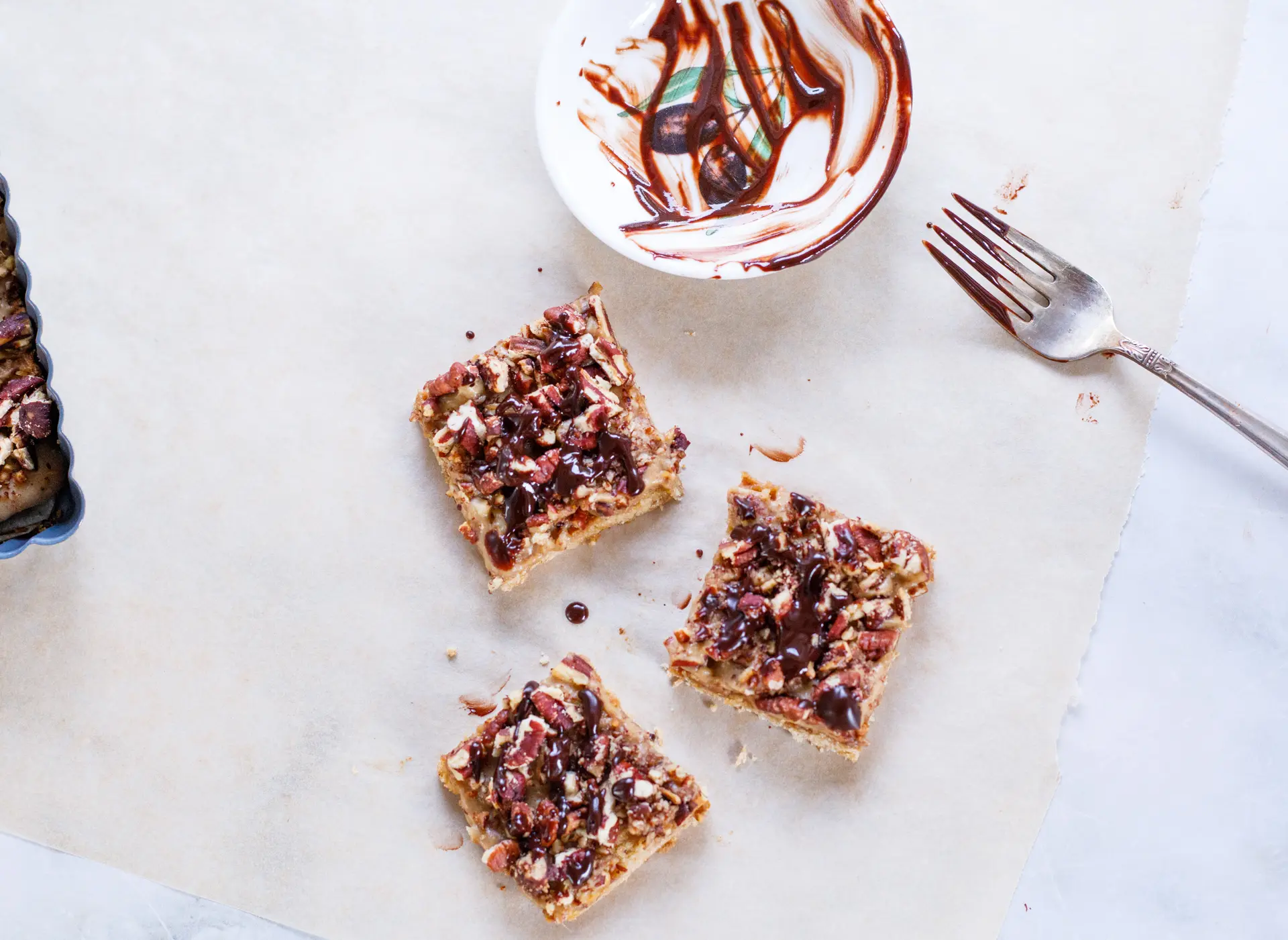 Pecan Caramel Bars with chocolate drizzled on top