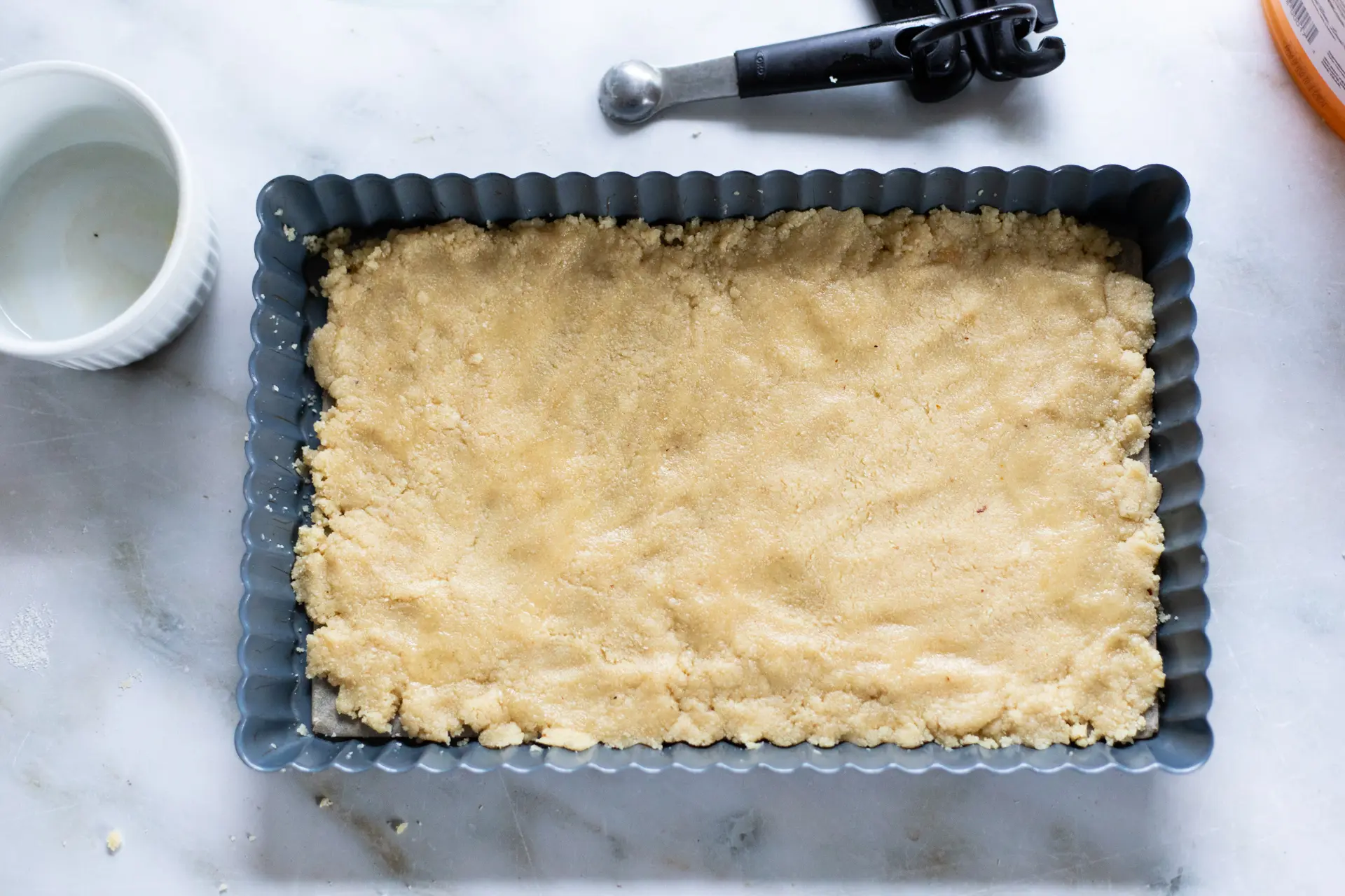 Pecan Caramel Bars shortbread crust in baking pan