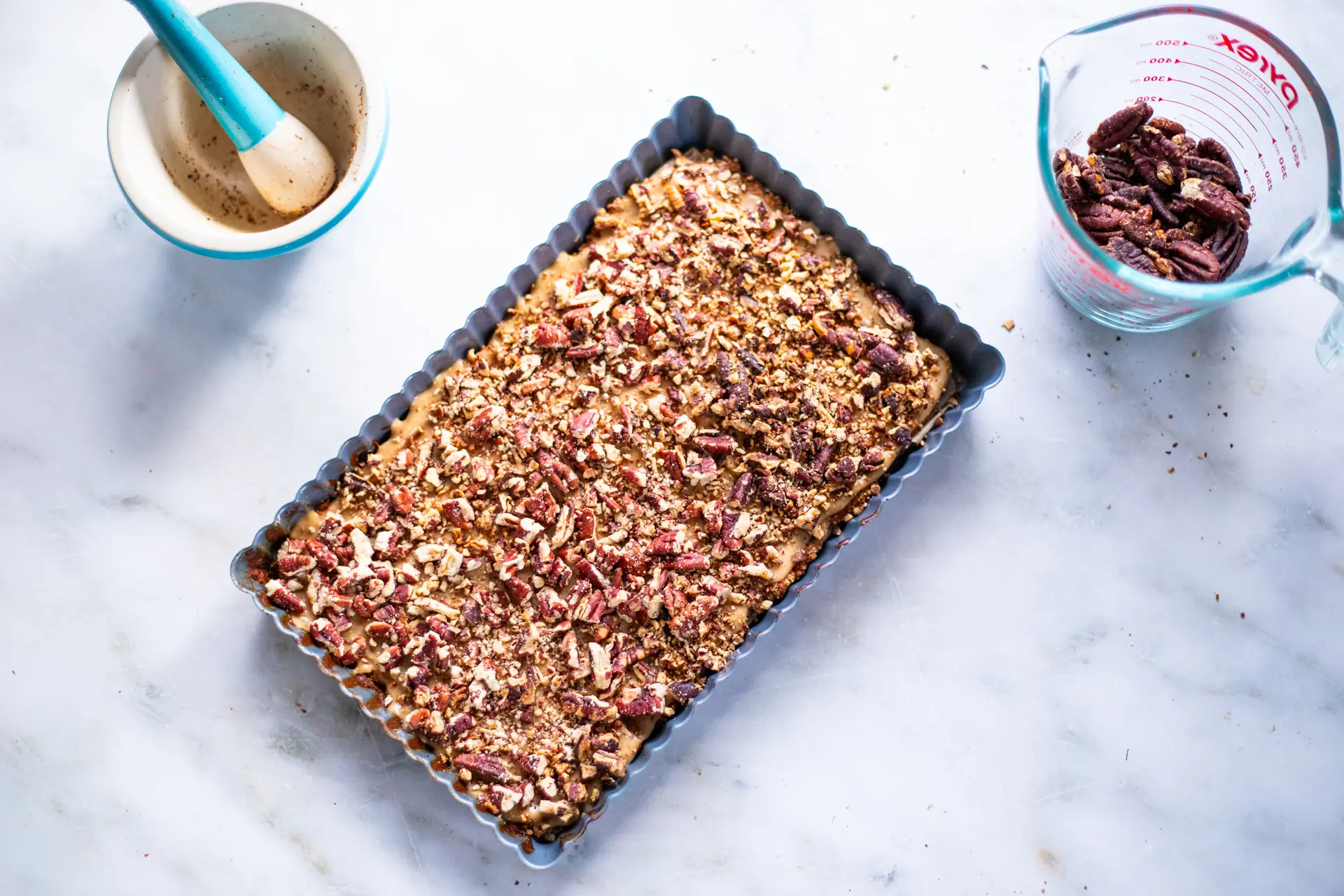 Chopped pecans spread across bars