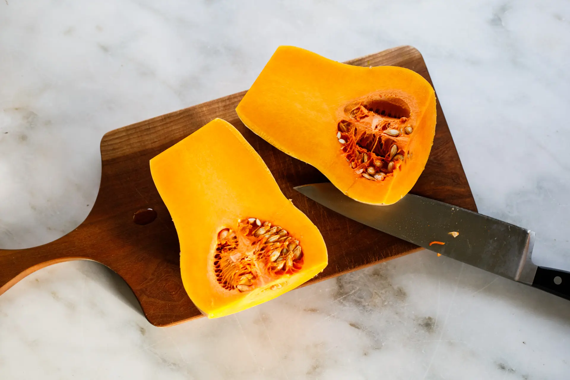 Sliced butternut squash split in half