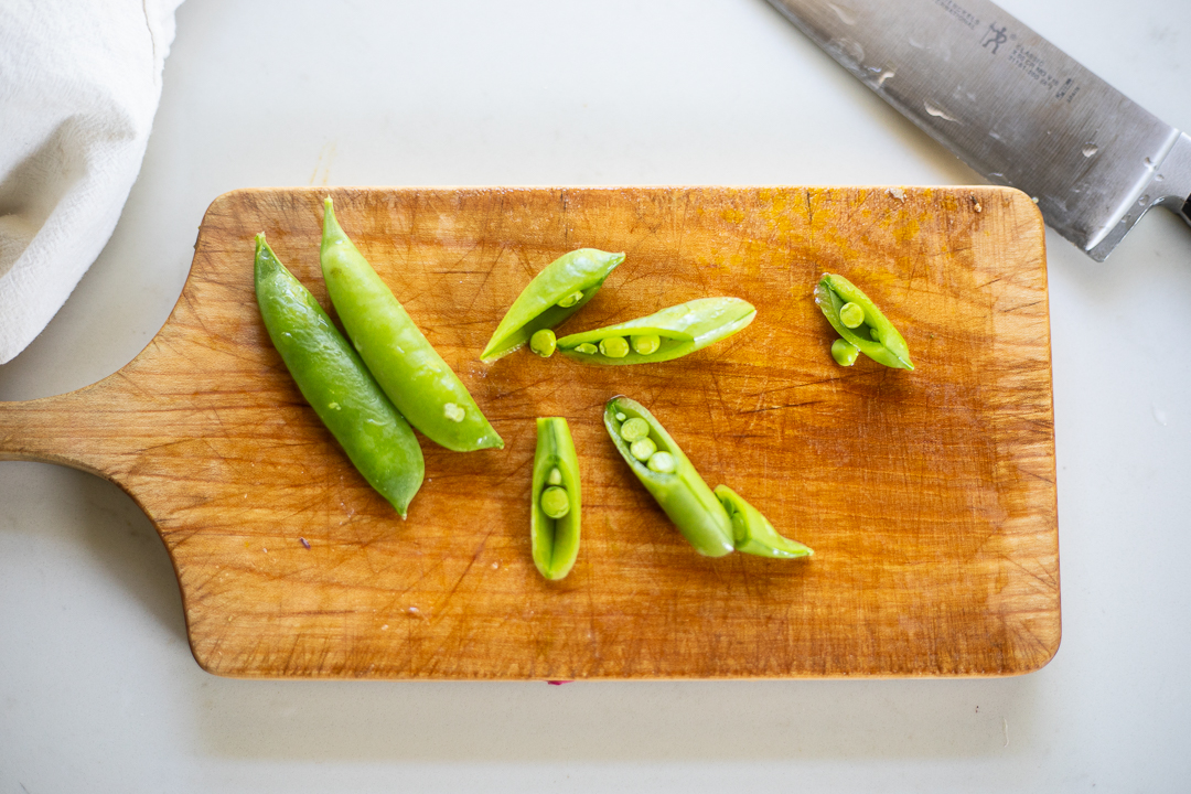 snap peas on cutting board