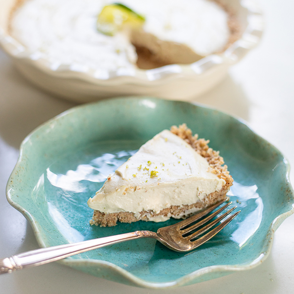 Slice of key lime pie on plate