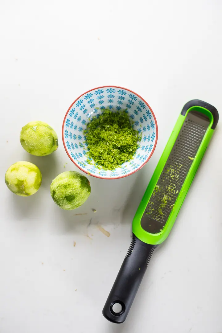 Lime zest with zester and limes