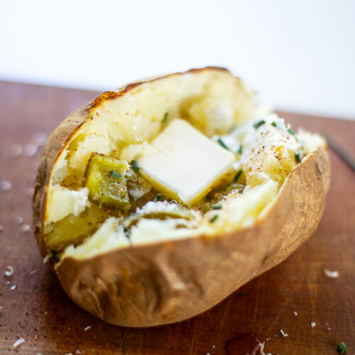 Baked potato with butter, chives, pepper