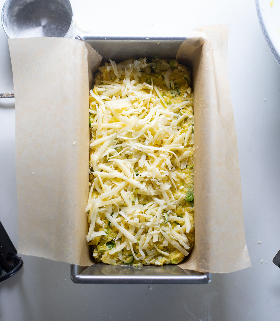 closeup of bread in baking pan topped with shredded cheese