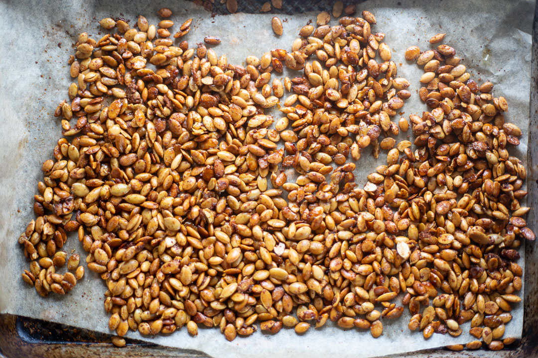 Salty and sweet pepitas on baking sheet